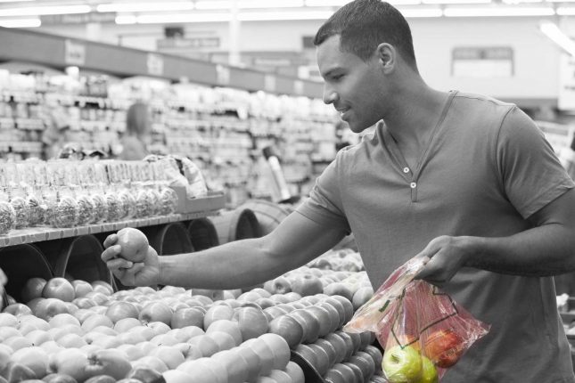 Man Selecting Fruits Wth Singlet Bag